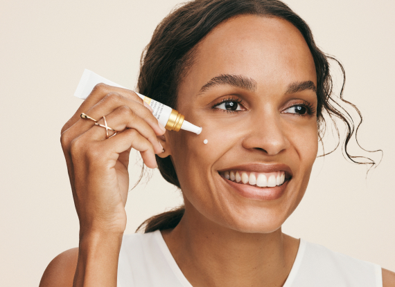 Woman using REVERSE Targeted Dark Spot Corrector.